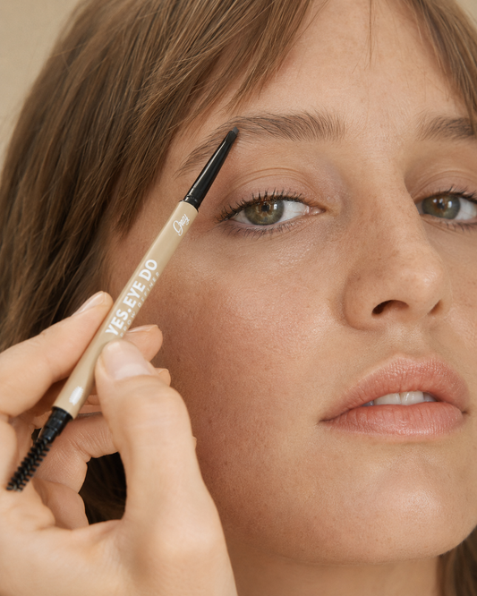 Model filling the tail of her brow with the Grey Micro Brow Pencil