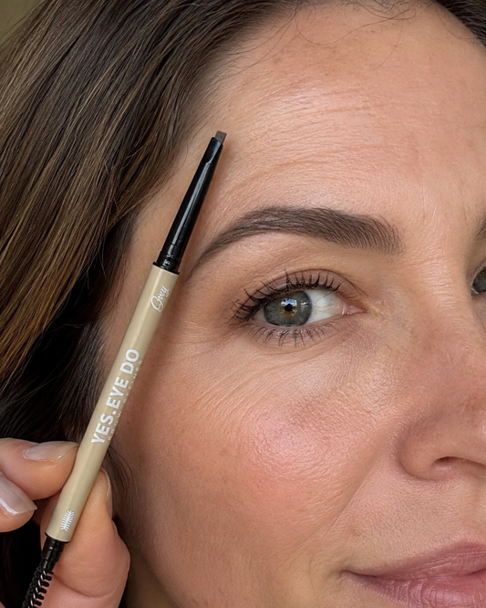Woman filling her brow with the Grey YES.EYE DO brow pencil, close-up of one eye