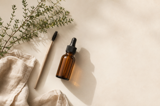 Brow serum dropper bottle with spoolie brush and dried botanicals