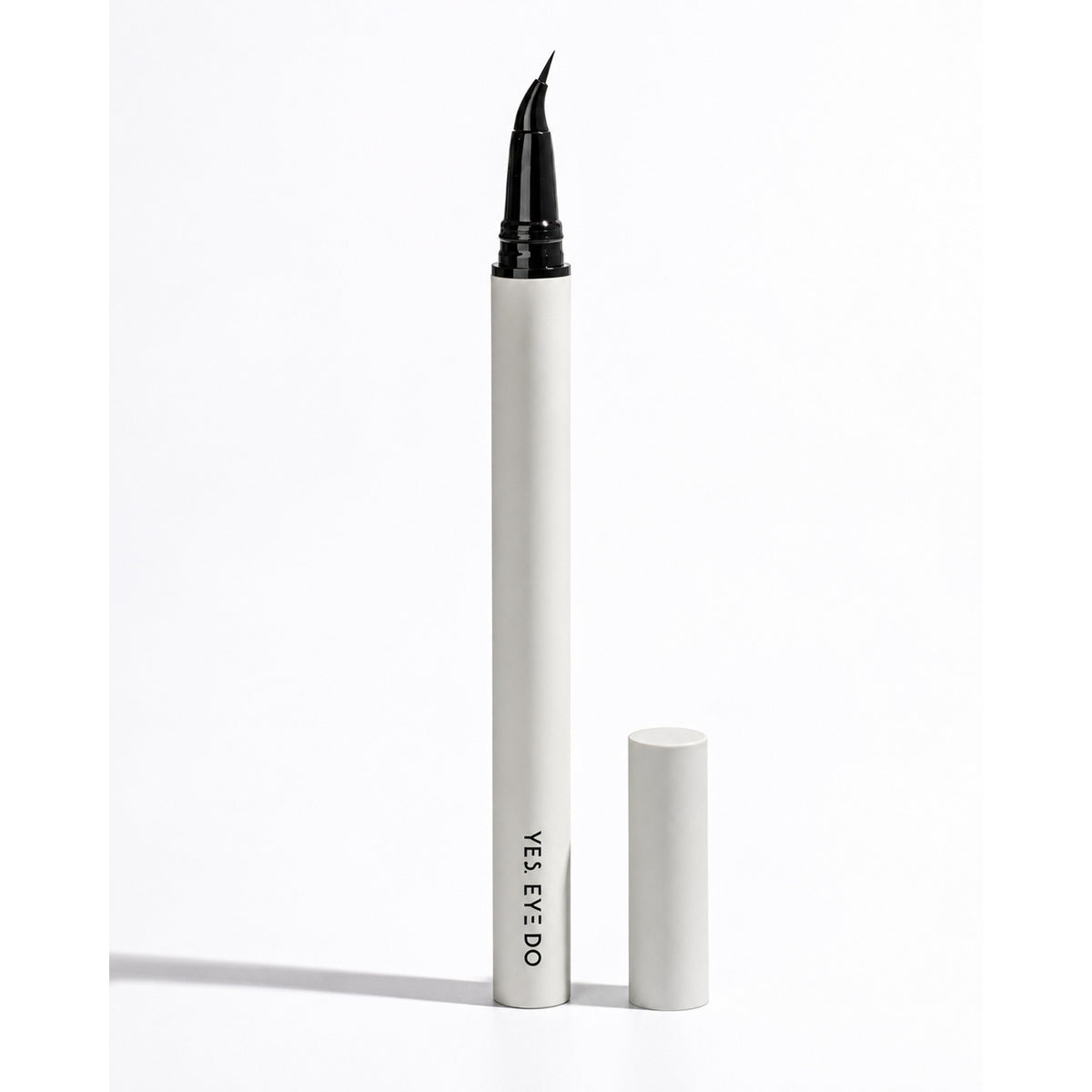 YES.EYE DO Angled Liquid Eyeliner pen with curved beak tip, cap removed, on a white background
