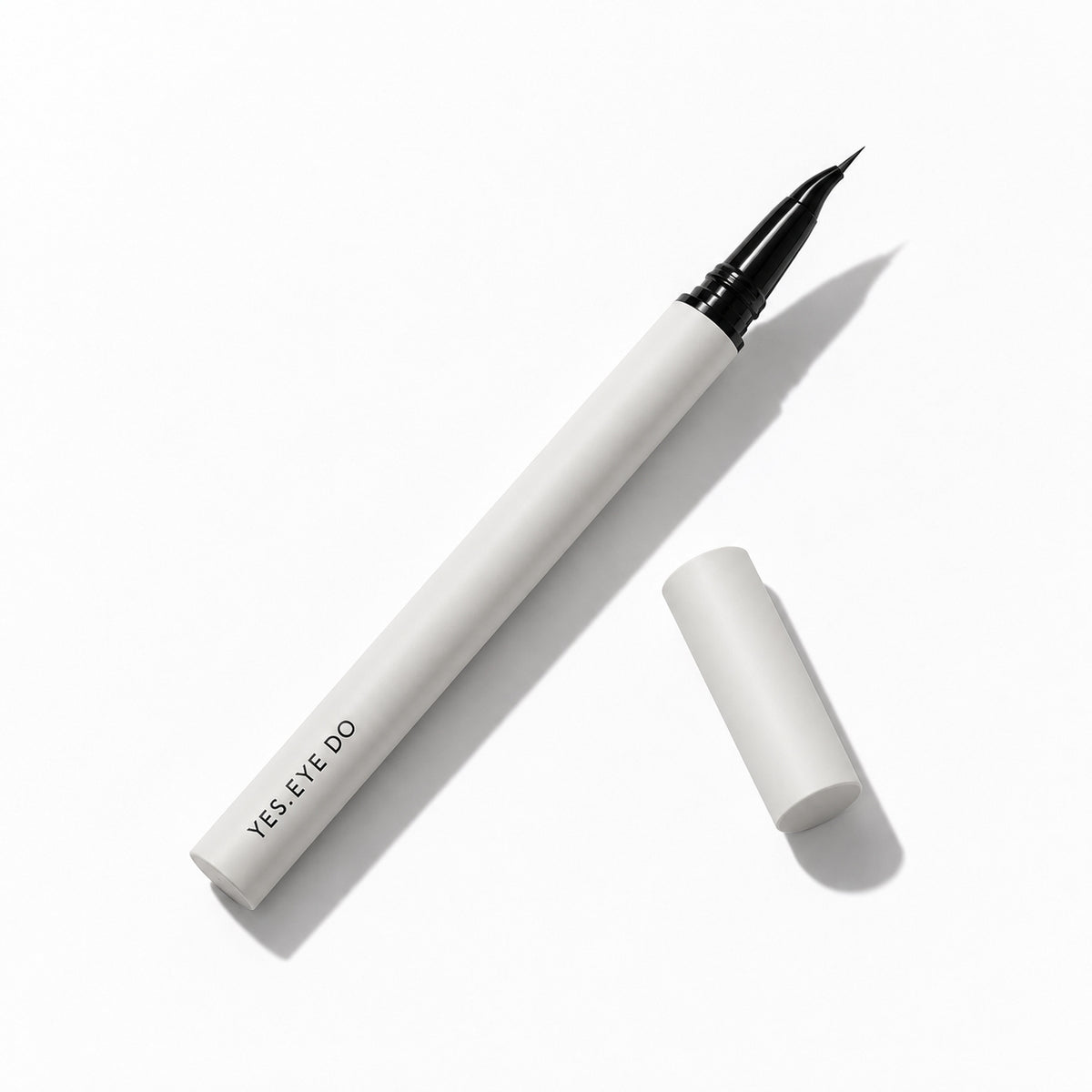YES.EYE DO angled liquid eyeliner lying flat with its cap removed, showing the fine beak tip