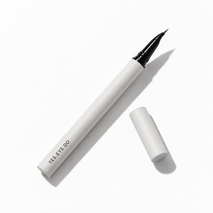 YES.EYE DO angled liquid eyeliner lying flat with its cap removed, showing the fine beak tip