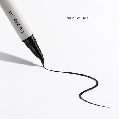 Angled eyeliner drawing a Midnight Noir line swatch on white paper
