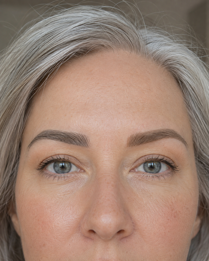 Model with silver hair and softly defined brows