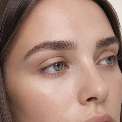 Model with full arched dark-brown pomade brows