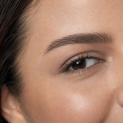 Bitter Chocolate shade reference: close-up of a groomed natural deep-brown brow and brown eye