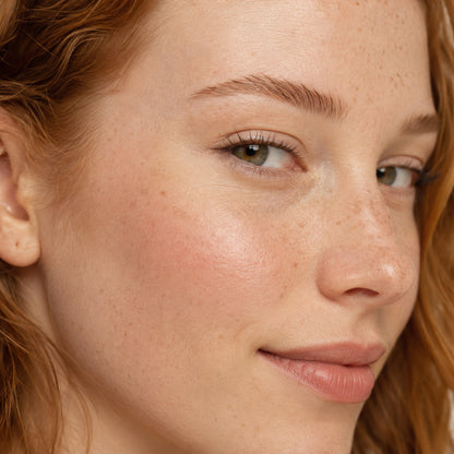 Walnut Whisper shade reference: auburn-red brows on freckled fair skin with strawberry-blonde hair